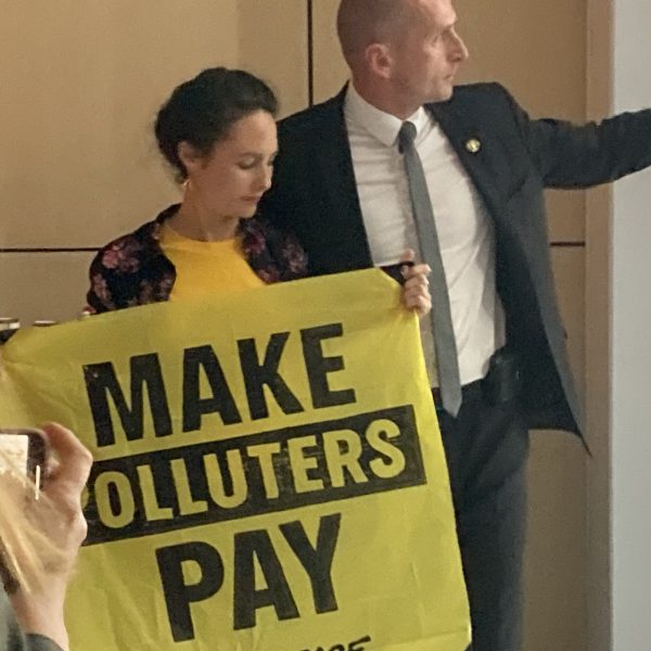 Environmental activist coming to the panel demanding polluters to pay taxes